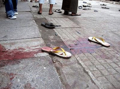 bloody sandals of burmese monk after soldiers attack